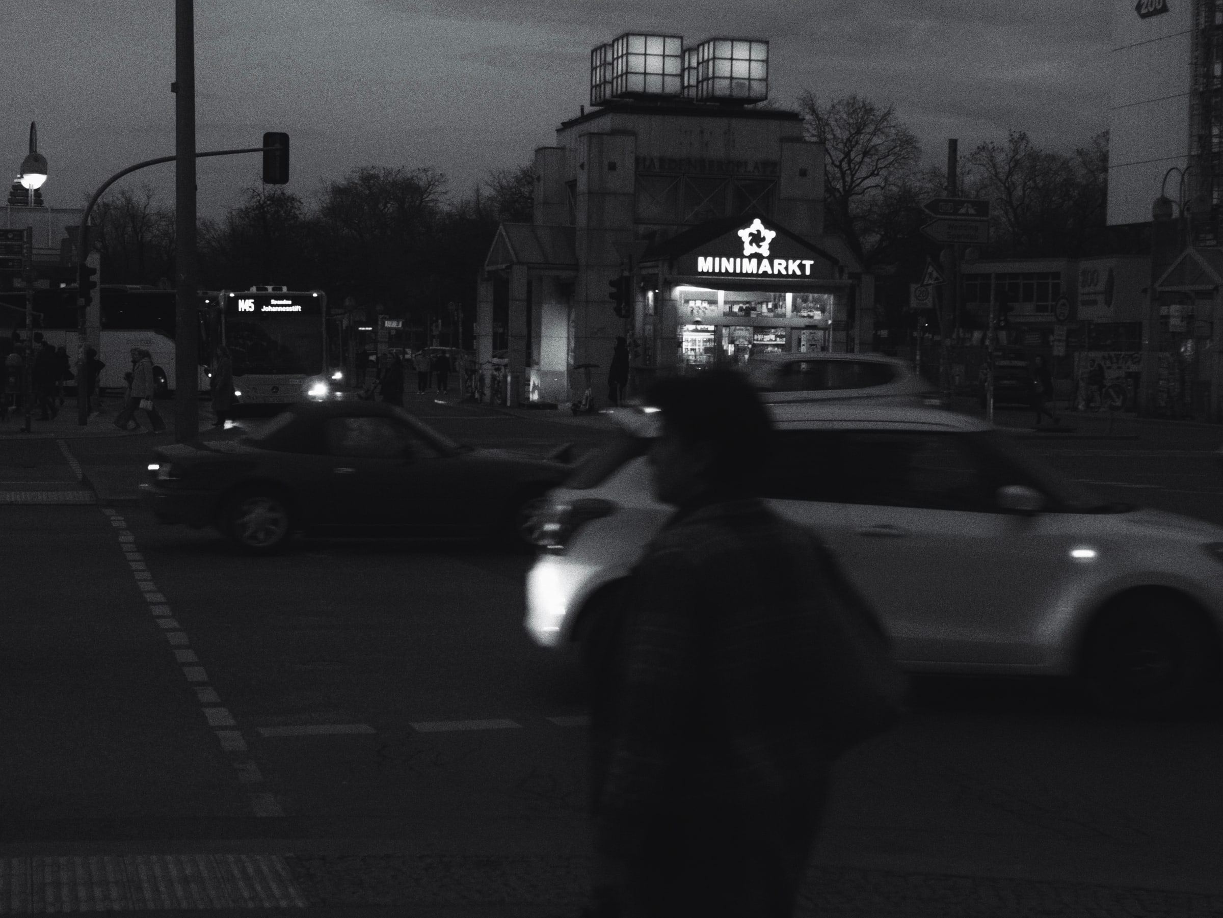 Figure crossing the street corner at night, second frame