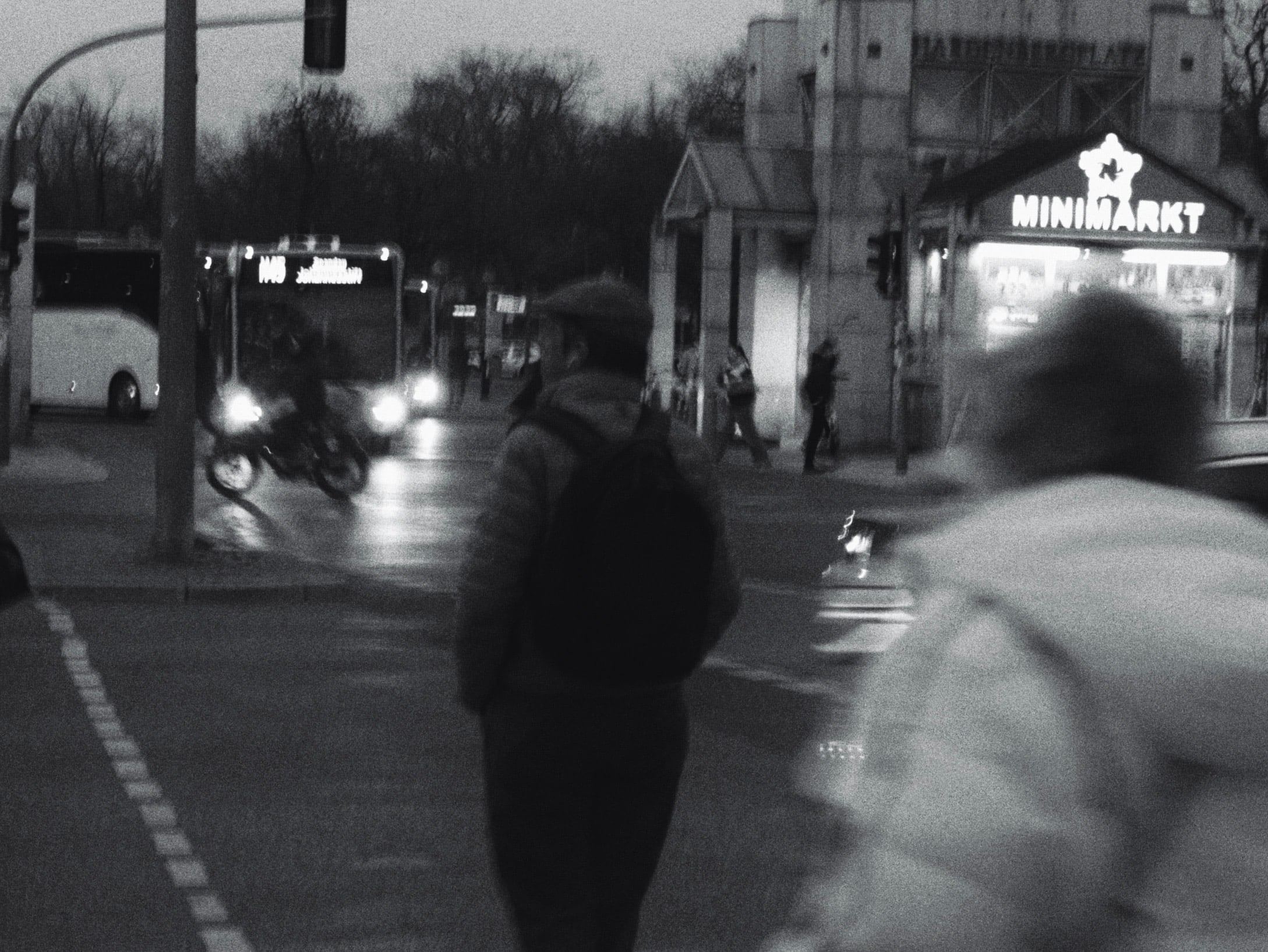 People crossing a street at night