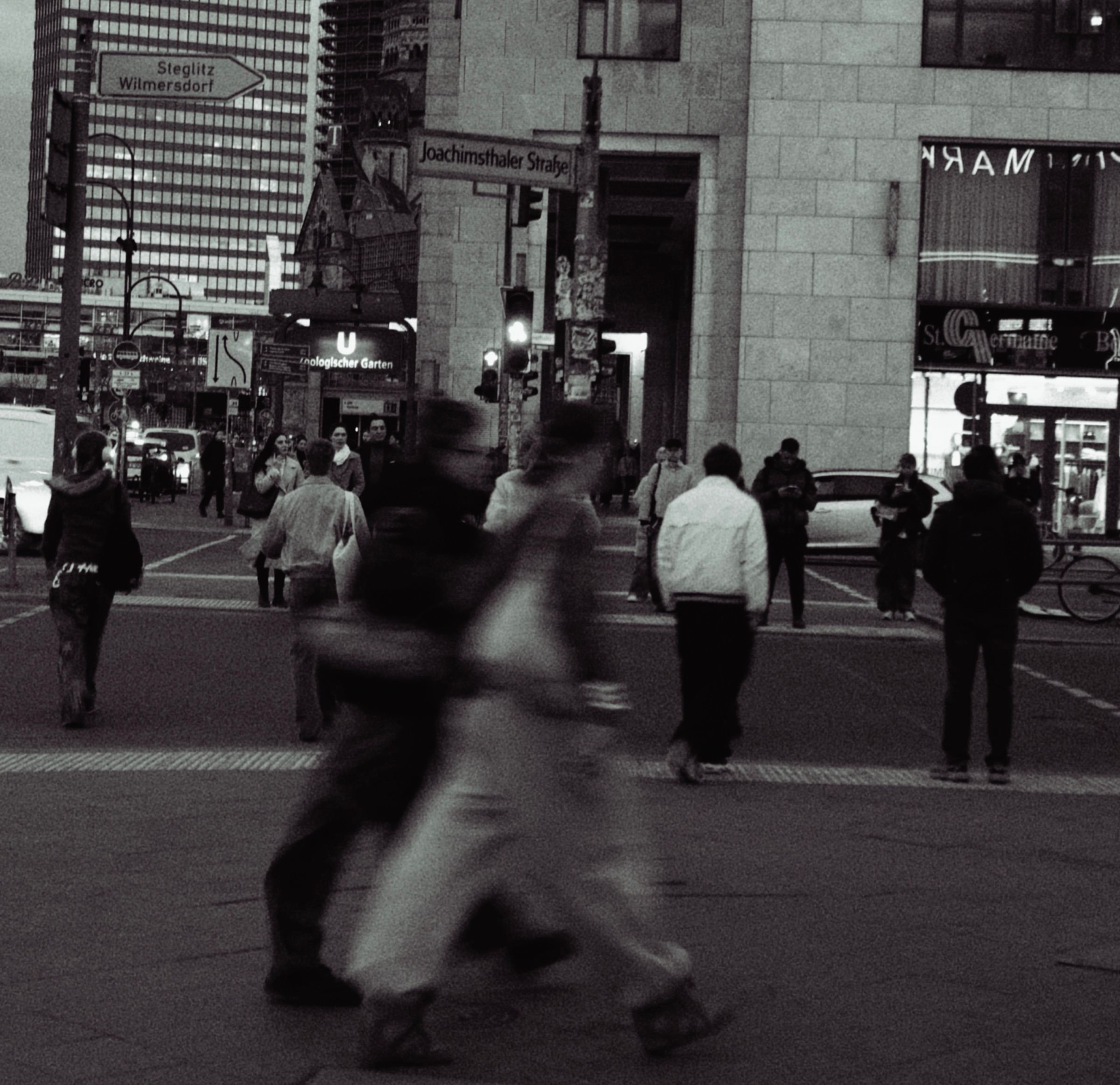 People crossing a busy street, blurred by motion