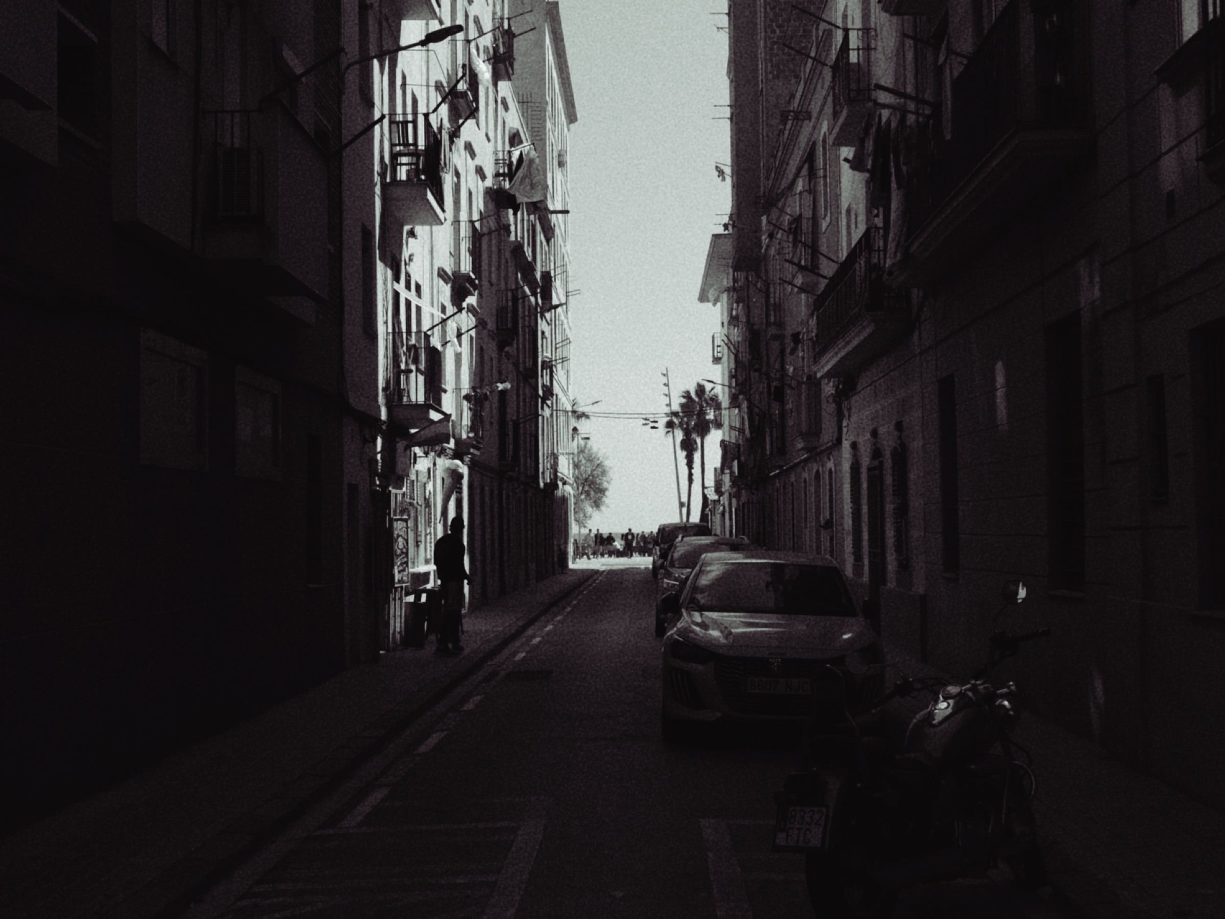 Narrow street between tall buildings