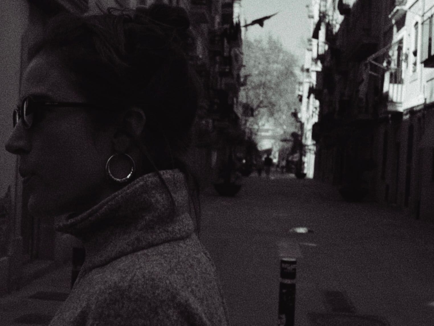 Woman in sunglasses on a narrow street