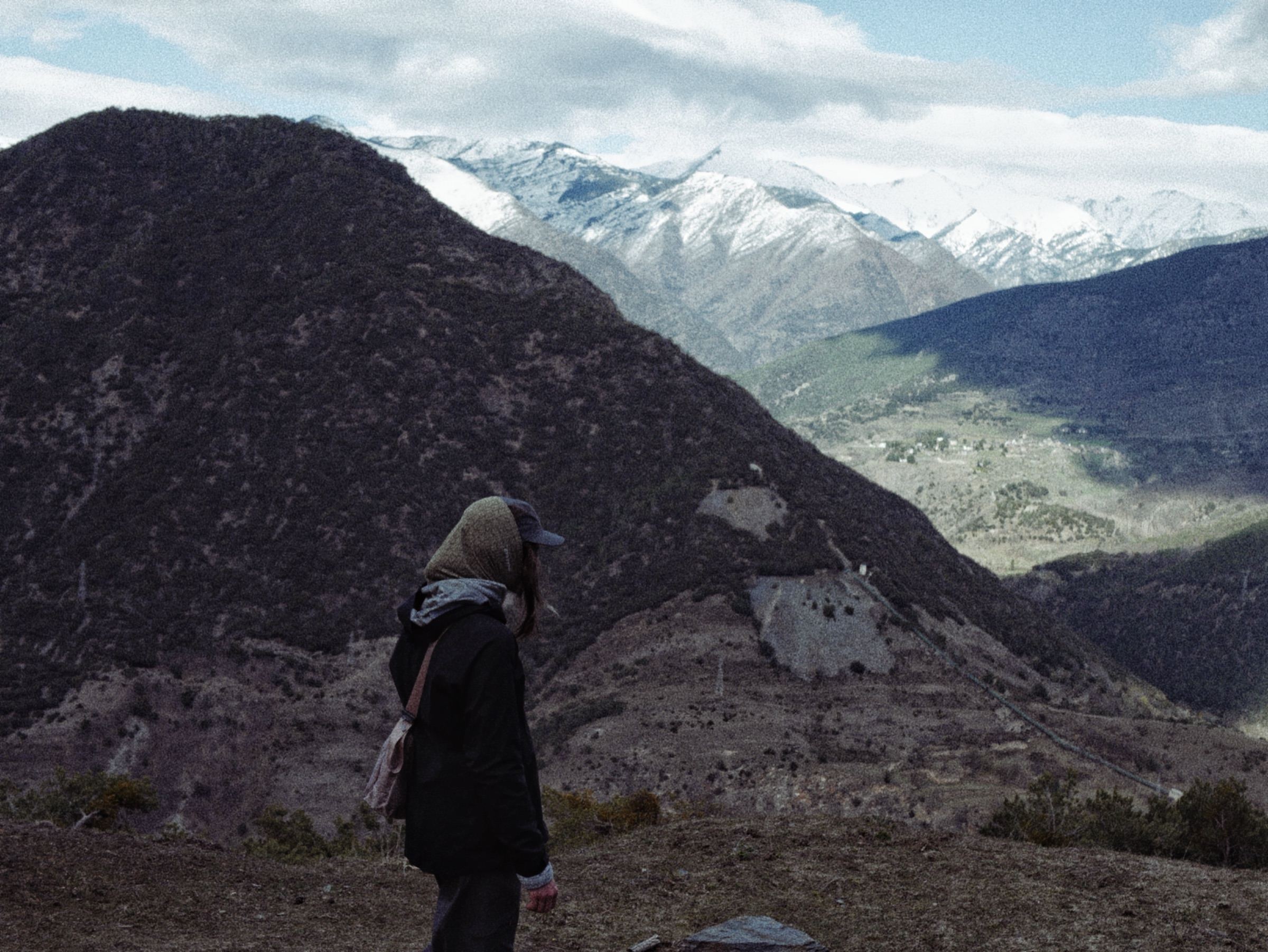 Person looking out over a mountain valley