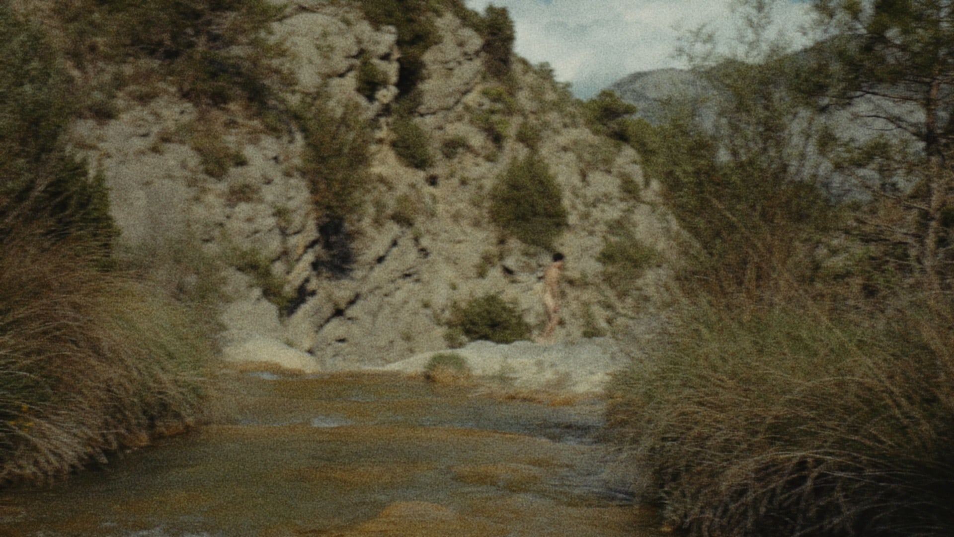 River running between rock walls and grasses